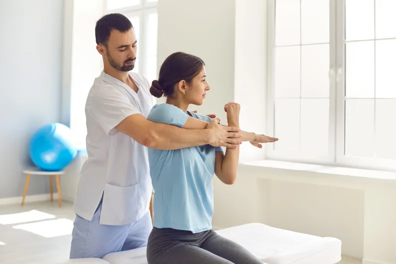 An osteopath with a client
